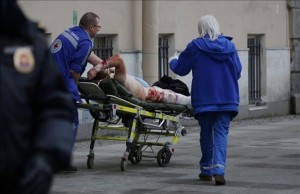 An injured person is helped by emergency services outside Sennaya Ploshchad metro station following explosions in two train carriages at metro stations in St Petersburg Russia April 3 2017 REUTERS Anton Vaganov
